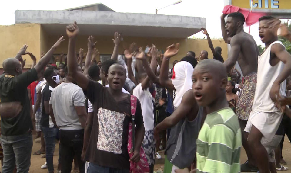 In this image made from video, a group of local residents demonstrate outside a coronavirus medical reception facility that was under construction in the Yopougon area of the commercial capital Abidjan, Ivory Coast, Monday, April 6, 2020. The protesters hampered the government's effort to build the emergency coronavirus medical reception facility in the crowded Yopougon area, ransacking the site and destroying equipment to be used to construct the center, saying they are worried that the triage center could expose their community to COVID-19. (AP Photo)