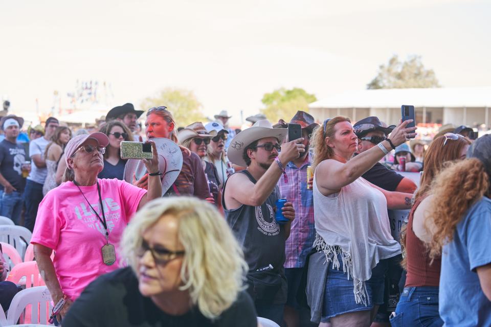 Fans hold their phones and record as Sawyer Brown performs during Country Thunder 2022 on April 10, 2022, in Florence, Arizona.