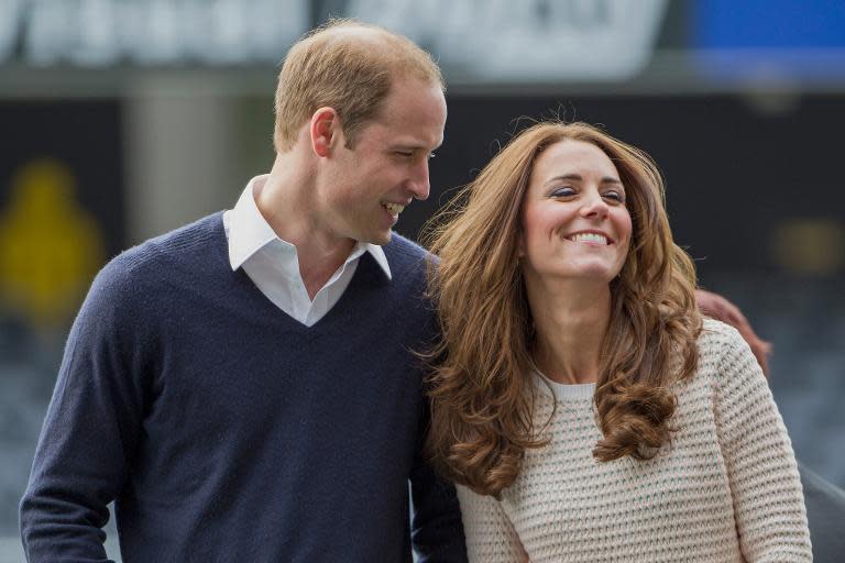 Prince William (L) and his wife Catherine, the Duchess of Cambridge, attend a children's rugby tournament during a visit to Forsyth Barr Stadium in Dunedin on April 13, 2014