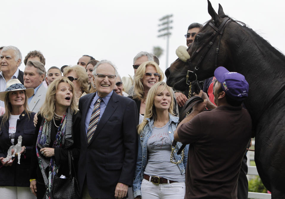 FILE - Race horse owner Jerry Moss, center, his wife Ann, center left, and actress Bo Derek, far left, celebrate after Zenyatta, right, won the Vanity Handicap horse race at Hollywood Park in Inglewood, Calif., on, June 13, 2010. Moss, a music industry giant who co-founded A&M Records, died Wednesday at his home in Bel Air, Calif. He was 88. (AP Photo/Jae C. Hong, File)