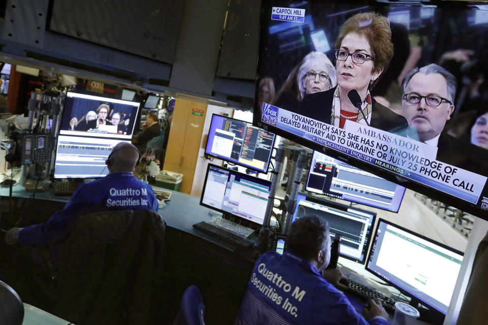 Former U.S. Ukraine Ambassador Marie Yovanovitch appears on televisions on the floor of the New York Stock Exchange, Friday, Nov. 15, 2019. Stocks are opening broadly higher on Wall Street as hopes continued to grow that the U.S. and China were moving closer to a deal on trade. (AP Photo/Richard Drew)