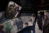 <p>Pakistani children seen from inside a rickshaw gathering in a slum on the outskirts of Islamabad, Pakistan, Feb. 1, 2011. (Photo: Muhammed Muheisen/AP) </p>