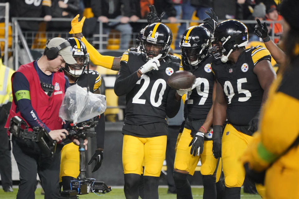 Pittsburgh Steelers cornerback Patrick Peterson (20) celebrates his interception in the end zone with teammates Levi Wallace (29) and Keeanu Benton (95) during the first half of an NFL football game against the Cincinnati Bengals, Saturday, Dec. 23, 2023, in Pittsburgh. (AP Photo/Gene J. Puskar)