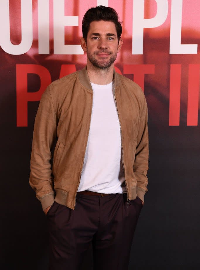 John Krasinksi with his hands in his pockets wearing a suede jacket