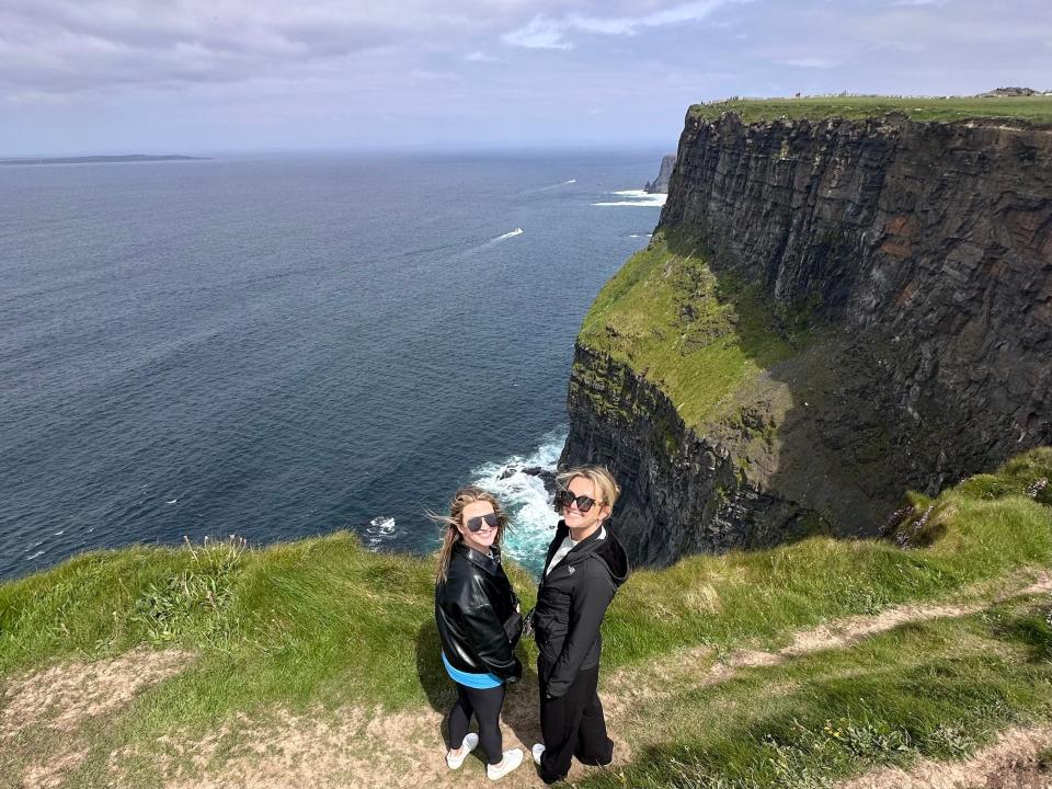 Christen Puckett and Jordan Carlyle standing at the Cliffs of Moher in Ireland