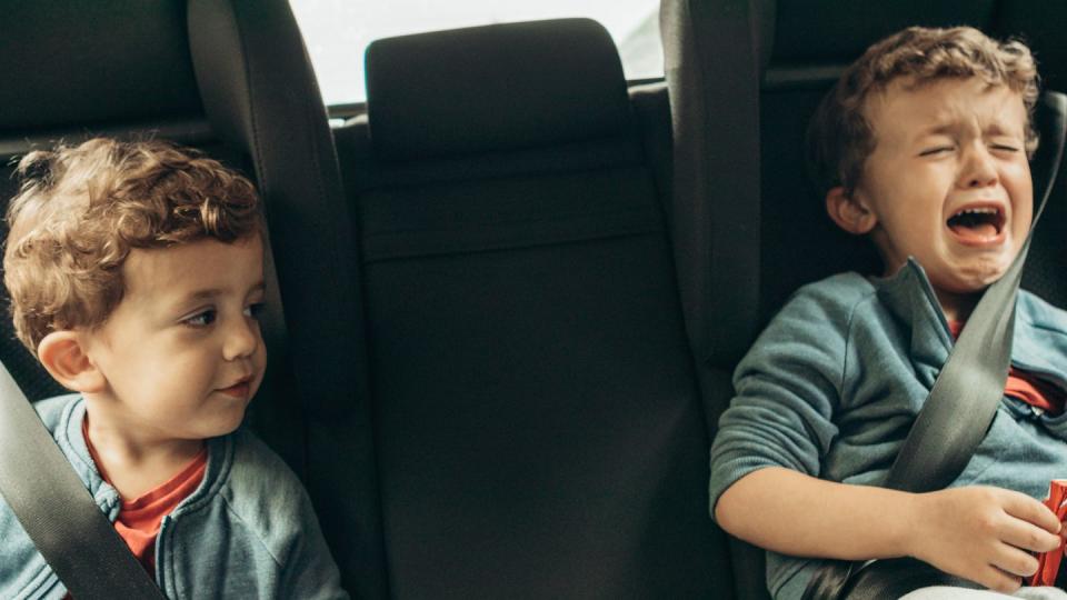 two boys in car seats in back seat