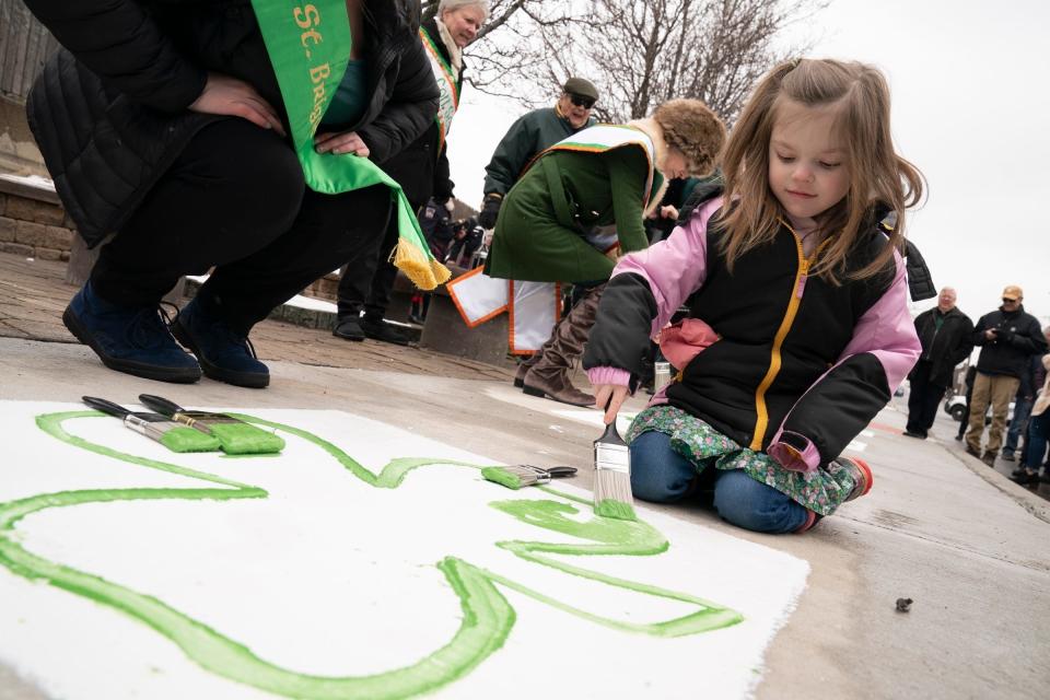 Sloane McCarver, 5, of Grosse Pointe Farms, paints a shamrock during the kickoff of St. Patrick's Parade weekend held Friday, March 11, 2022, at the United Irish Societies Plaza in Corktown in Detroit.