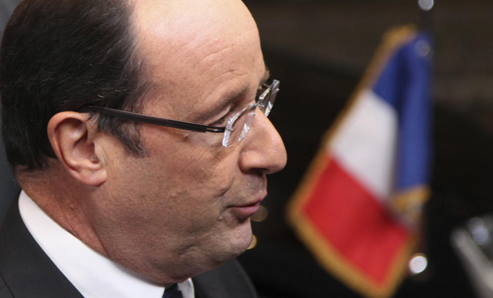 French President Francois Hollande speaks with the media as he arrives for an EU summit in Brussels on Thursday, Nov. 22, 2012. EU leaders begin what is expected to be a marathon summit on the budget for the years 2014-2020. The meeting could last through Saturday and break up with no result and lots of finger-pointing. (AP Photo/Yves Logghe)