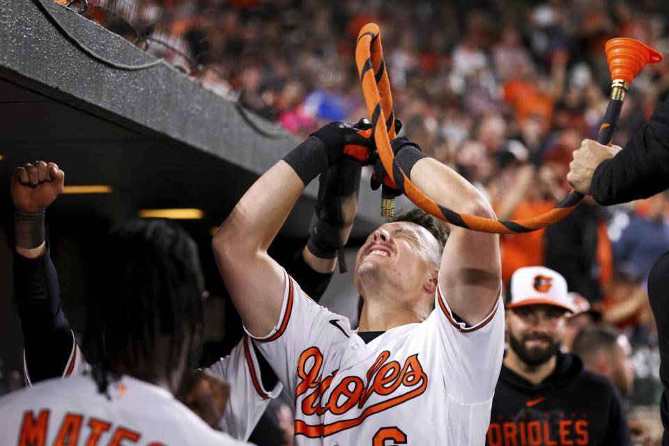 Baltimore Orioles first baseman Ryan Mountcastle (6) raises a water funnel in the dugout after scoring a home run during the fifth inning of a baseball game against the Oakland Athletics, Tuesday, April 11, 2023, in Baltimore. (AP Photo/Julia Nikhinson)