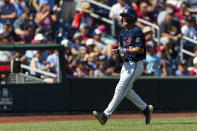 Mississippi utility Justin Bench (8) celebrates his run in the fourth inning against Mississippi during an NCAA College World Series baseball game Thursday, June 23, 2022, in Omaha, Neb. (AP Photo/John Peterson)