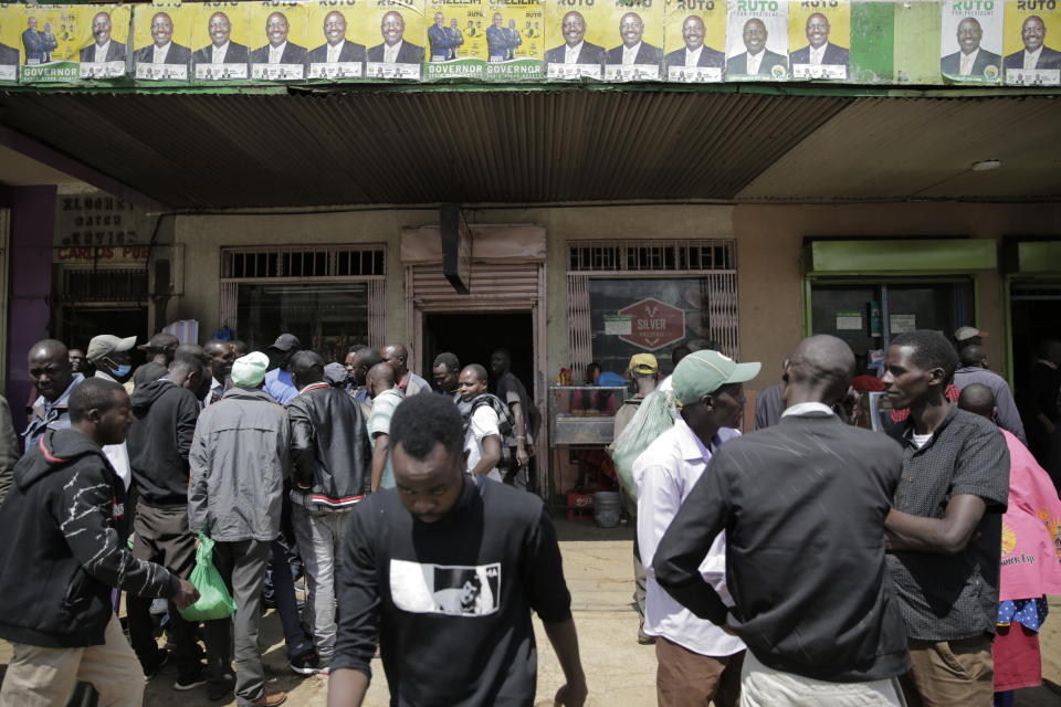 People gather in Eldoret, Kenya, Wednesday Aug. 10, 2022. Kenyans are waiting for results in the presidential elections that saw opposition leader Raila Odinga facing Deputy President William Rutoto in their bid to succeed President Uhuru Kenyatta who stayed in power for a decade. (AP Photo/Brian Inganga)