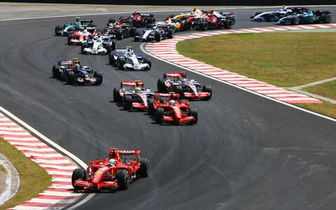 Felipe Massa of Brazil and Ferrari leads into turn one as Kimi Raikkonen of Finland and Ferrari overtakes Lewis Hamilton of Great Britain and McLaren Mercedes at the start of the Brazilian Formula One Grand Prix at the Autodromo Interlagos on October 21, 2007 in Sao Paulo, Brazil - Credit: Paul Gilham/Getty Images