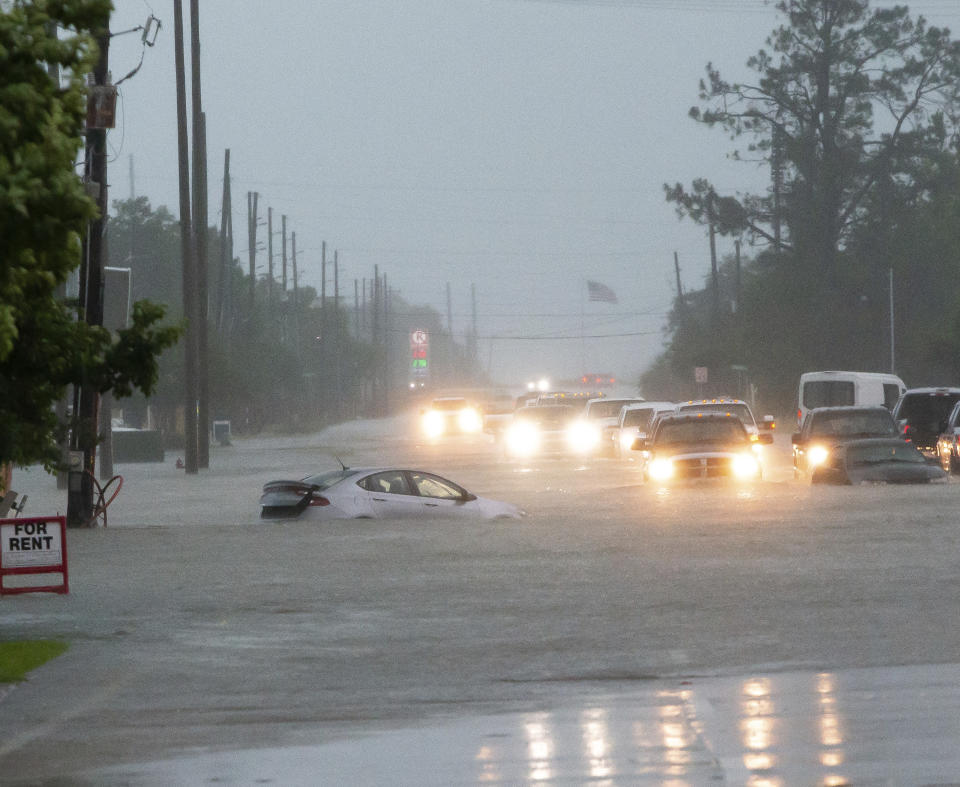 Cars sit stalled on a flooded Nelson Road from heavy rains in Lake Charles, La., Monday, May 17, 2021. (Rick Hickman/American Press via AP)