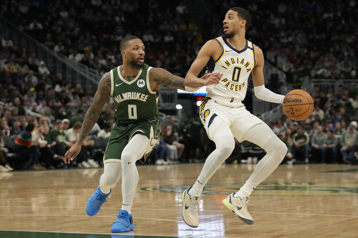 MILWAUKEE, WISCONSIN - JANUARY 01: Tyrese Haliburton #0 of the Indiana Pacers dribbles the ball against Damian Lillard #0 of the Milwaukee Bucks during the second half at Fiserv Forum on January 01, 2024 in Milwaukee, Wisconsin. NOTE TO USER: User expressly acknowledges and agrees that, by downloading and or using this photograph, User is consenting to the terms and conditions of the Getty Images License Agreement (Photo by Patrick McDermott/Getty Images )