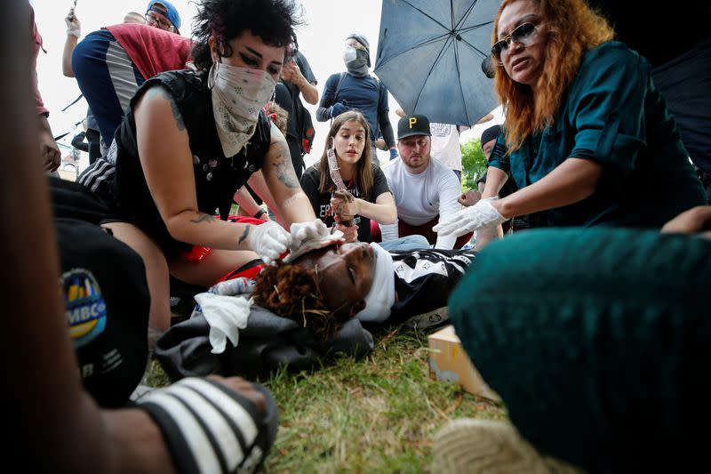 People gather at the Minneapolis Police Department's Third Precinct station to protest the death of George Floyd in Minneapolis, Minnesota