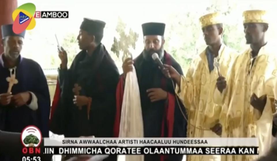 In this image taken from OBN video, the funeral for Ethiopia singer Hachalu Hundessa takes place in Ambo, Ethiopia, Thursday July 2, 2020. More than 80 people have been killed in unrest in Ethiopia after the popular singer Hachalu Hundessa was shot dead this week. He was buried Thursday amid tight security. He had been a prominent voice in anti-government protests that led to a change in leadership in 2018. (OBN via AP)