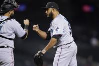 Miami Marlins relief pitcher Yimi Garcia, right, celebrates with catcher Sandy Leon after the team's baseball game against the Arizona Diamondbacks on Wednesday, May 12, 2021, in Phoenix. The Marlins won 3-2. (AP Photo/Ross D. Franklin)