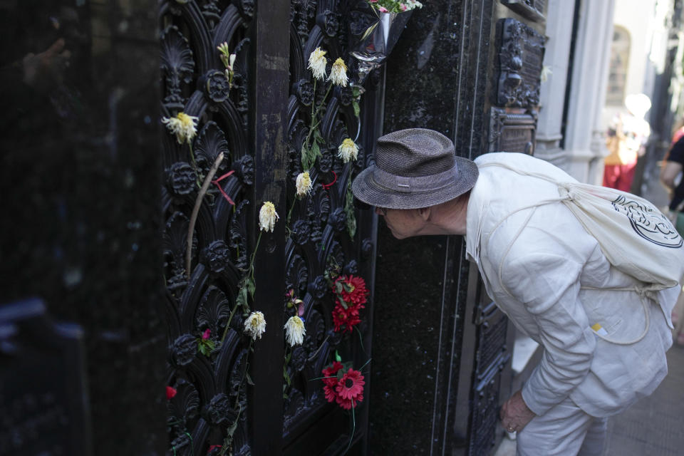 A tourist peeks into the mausoleum housing the remains of Argentine former first lady María Eva Duarte de Perón, better known as Eva Perón, or Evita, at the Recoleta cemetery in Buenos Aires, Argentina, Tuesday, Feb. 13, 2024. (AP Photo/Natacha Pisarenko)