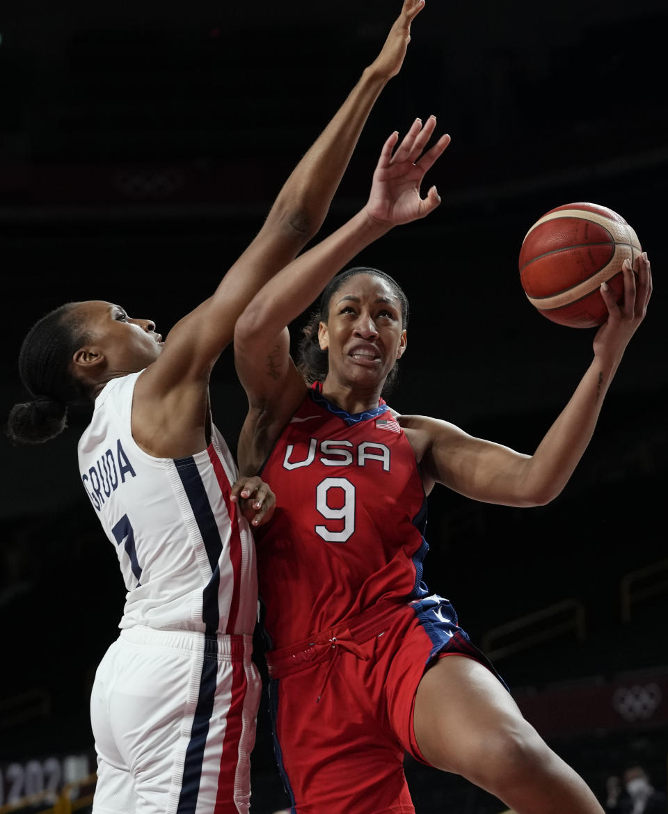 United States' A'Ja Wilson (9) drives against France's Sandrine Gruda (7) during women's basketball preliminary round game at the 2020 Summer Olympics, Monday, Aug. 2, 2021, in Saitama, Japan. (AP Photo/Eric Gay)