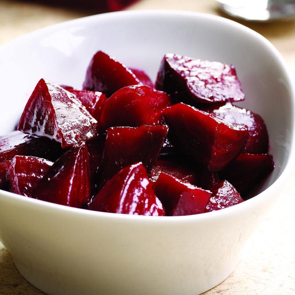 close-up of cubes cooked beets in a white bowl