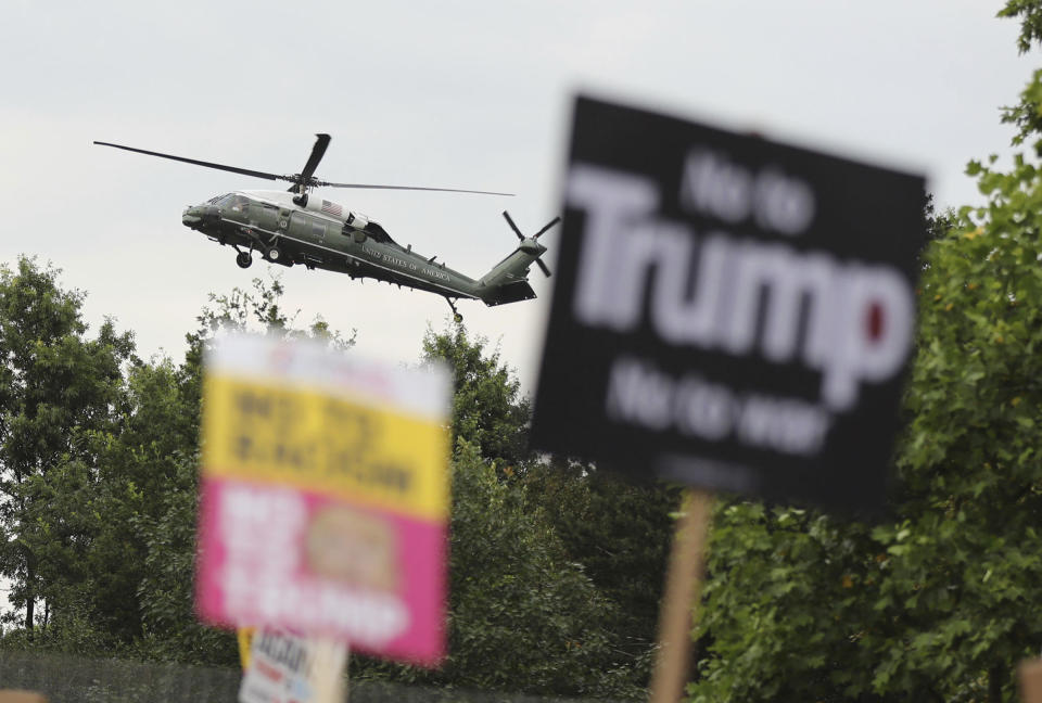 <p>A U.S. presidential helicopter lands on the grounds of the U.S. ambassador’s residence in Regent’s Park, London, while demonstrators protest against Donald Trump’s visit to the U.K., July 12, 2018. (Photo: Gareth Fuller/PA via AP) </p>