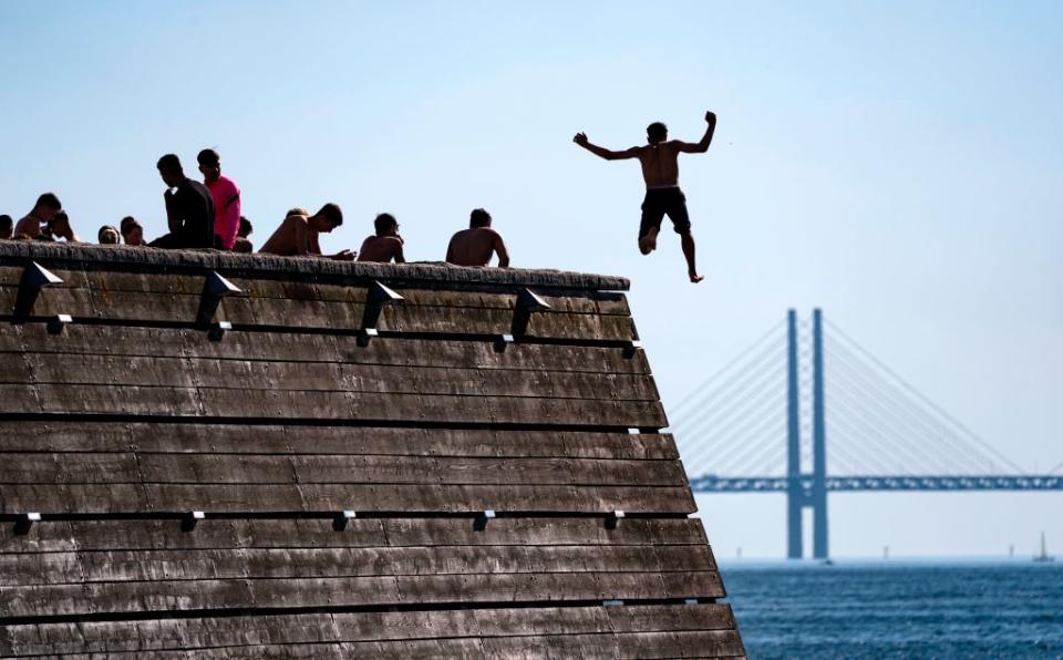 Swimmers brave the water in the shadow of the Oresund Bridge - getty