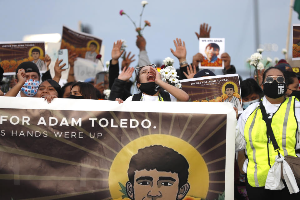 Demonstrators attend a peace walk honoring the life of police shooting victim 13-year-old Adam Toledo, Sunday, April 18, 2021, in Chicago's Little Village neighborhood. (AP Photo/Shafkat Anowar)