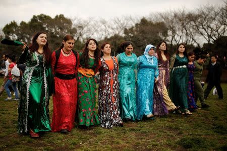 Kurdish women dance during Newroz celebrations in a public park in Warabi, north of Tokyo, March 20, 2016. REUTERS/Thomas Peter