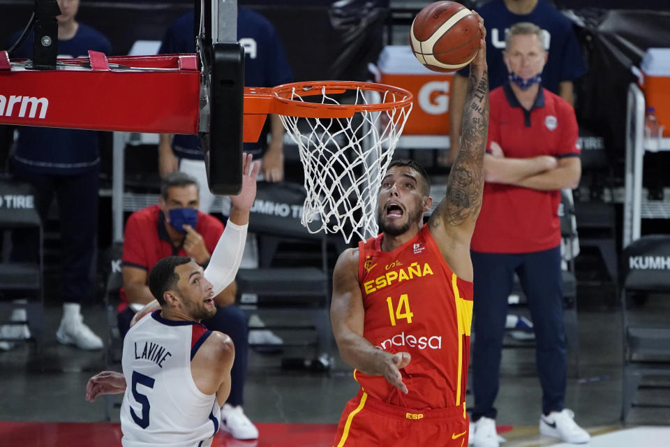 Spain's Willy Hernangomez (14) dunks against United States' Zachary Lavine (5) during the second half of an exhibition basketball game in preparation for the Olympics, Sunday, July 18, 2021, in Las Vegas. (AP Photo/John Locher)