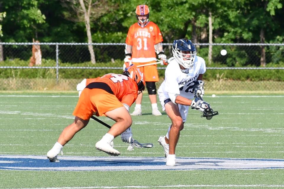 St. Augustine senior Jackson Tinari wins a faceoff cleanly against Mountain Lakes senior Justin Hernando