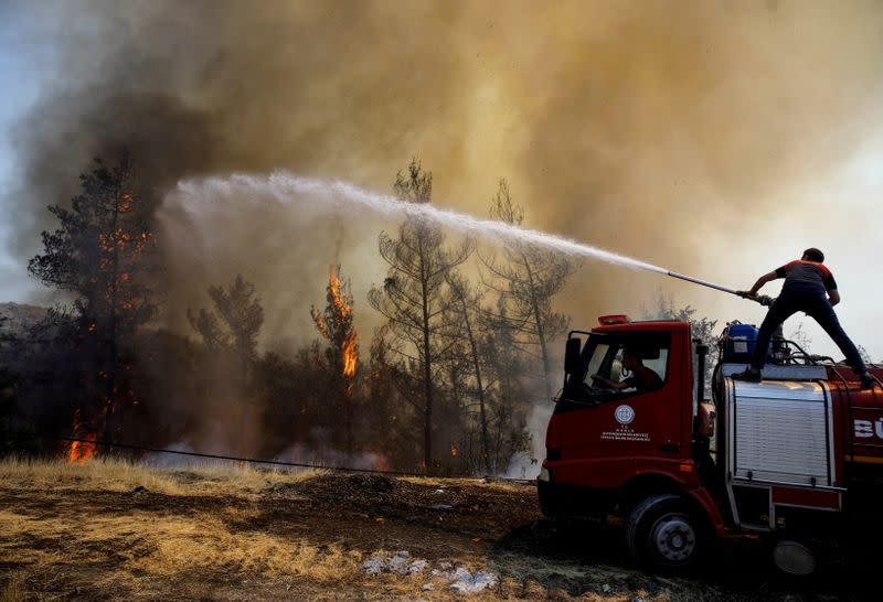 FILE PHOTO: A firefighter tries to extinguish a wildfire near Marmaris, Turkey, August 1,