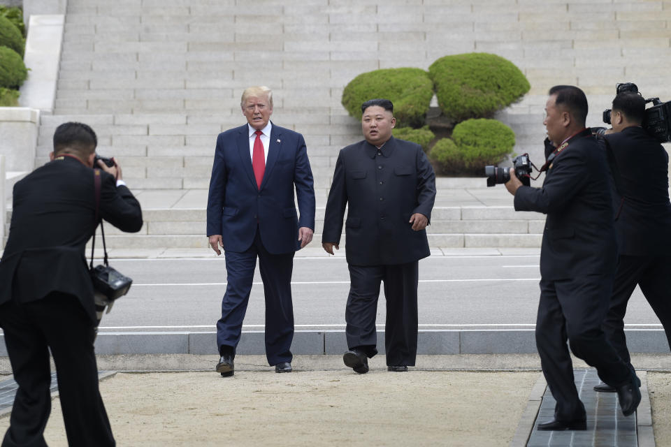 FILE - In this June 30, 2019, file photo, President Donald Trump, center left, and North Korean leader Kim Jong Un walk on the North Korean side at the border village of Panmunjom in the Demilitarized Zone. South Korea's President Moon Jae-in calls the recent U.S.-North Korean summit at the Korean border an end of mutual hostility between the countries. (AP Photo/Susan Walsh, File)