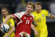 Denmark's Rasmus Hojlund, foreground, battles for the ball with Kazakhstan's Alexandr Marochkin, right, during the Euro 2024 group H qualifying soccer match between Kazakhstan and Denmark at the Astana Arena stadium in Astana, Kazakhstan, Sunday, March 26, 2023. (AP Photo)