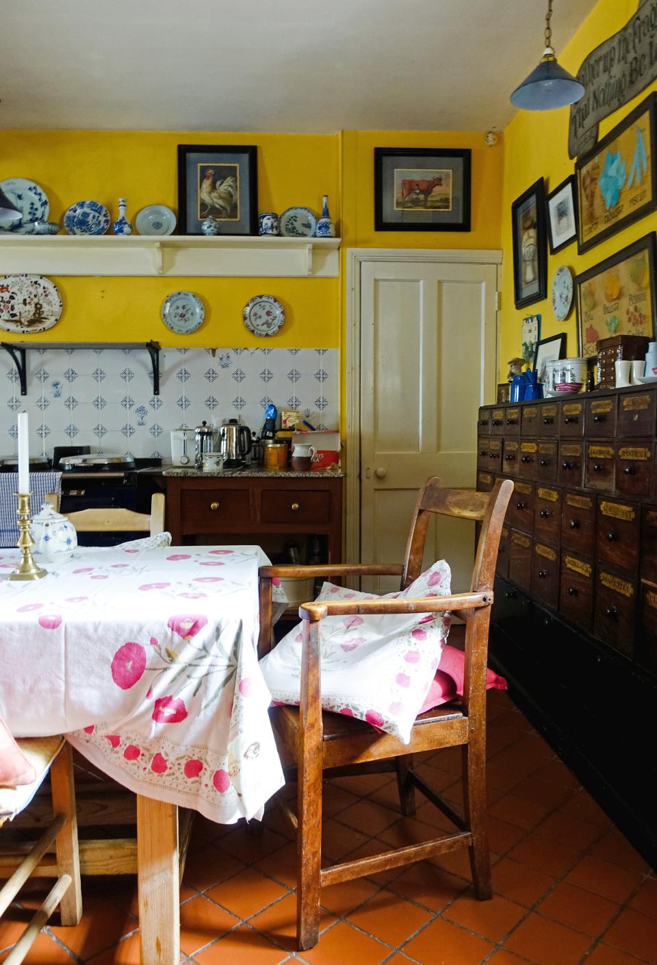 The yellow walls and Aga and Irish country furniture of this traditional family kitchen is one of two kitchens in the house—another commercial kitchen can cater up to 80 guests.