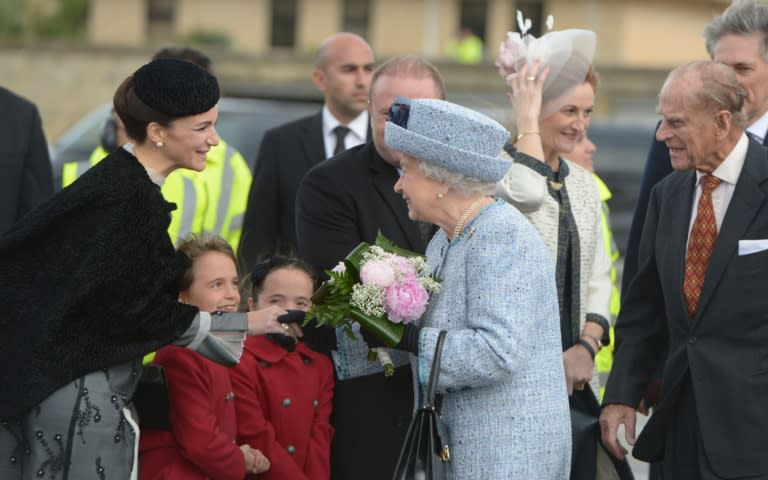 Michelle Muscat, wife of Malta's Prime Minister Joseph Muscat, welcomes Queen Elizabeth II (C) and her husband Prince Philip, Duke of Edinburgh, on November 26, 2015