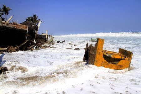 Buildings damaged by high waves are seen in Coyuca de Benitez, on the coast of Guerrero state, Mexico, in this May 4, 2015 file photo.REUTERS/Claudio Vargas