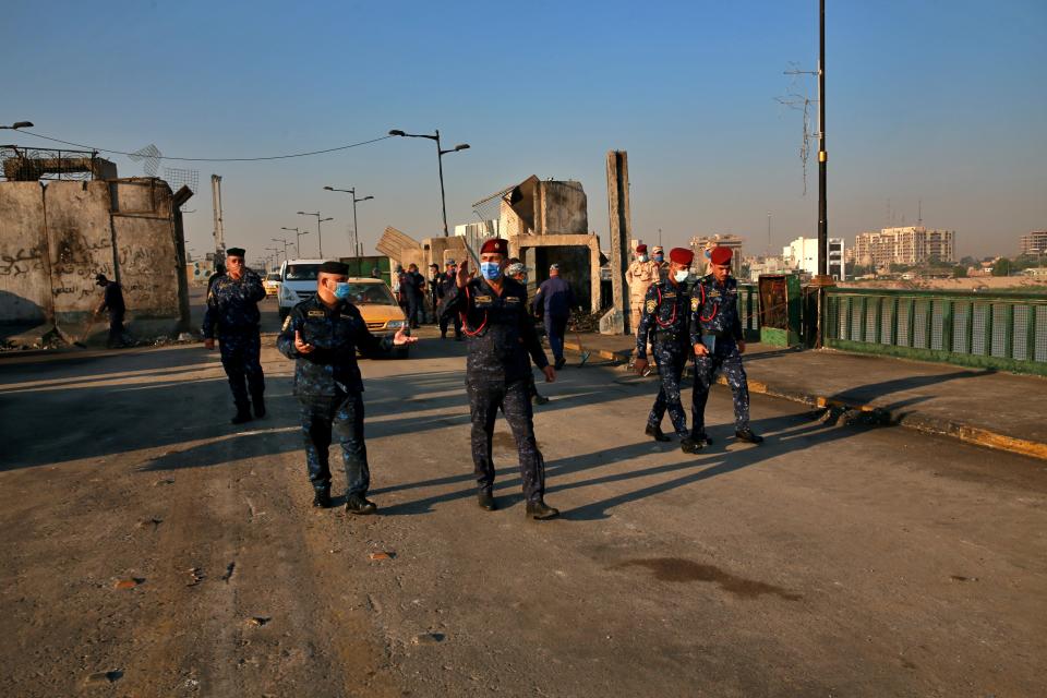 Security forces open anti-government protesters' site at the Joumhouriya Bridge that leads to the Green Zone government areas, in Baghdad, Iraq, Saturday, Oct. 31, 2020. (AP Photo/Khalid Mohammed)