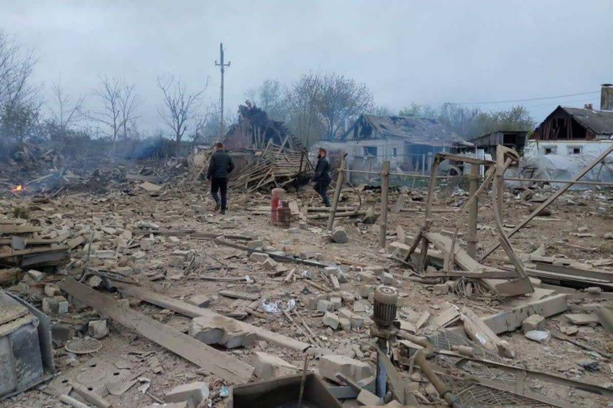 People are seen at the site of a residential area hit by a Russian military strike in Pavlohrad (via REUTERS)