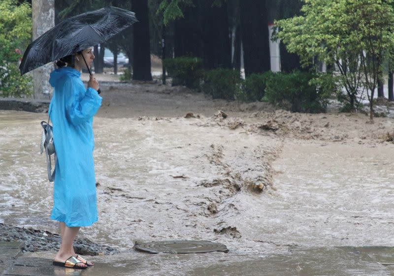 A woman looks at flowing water in Yalta