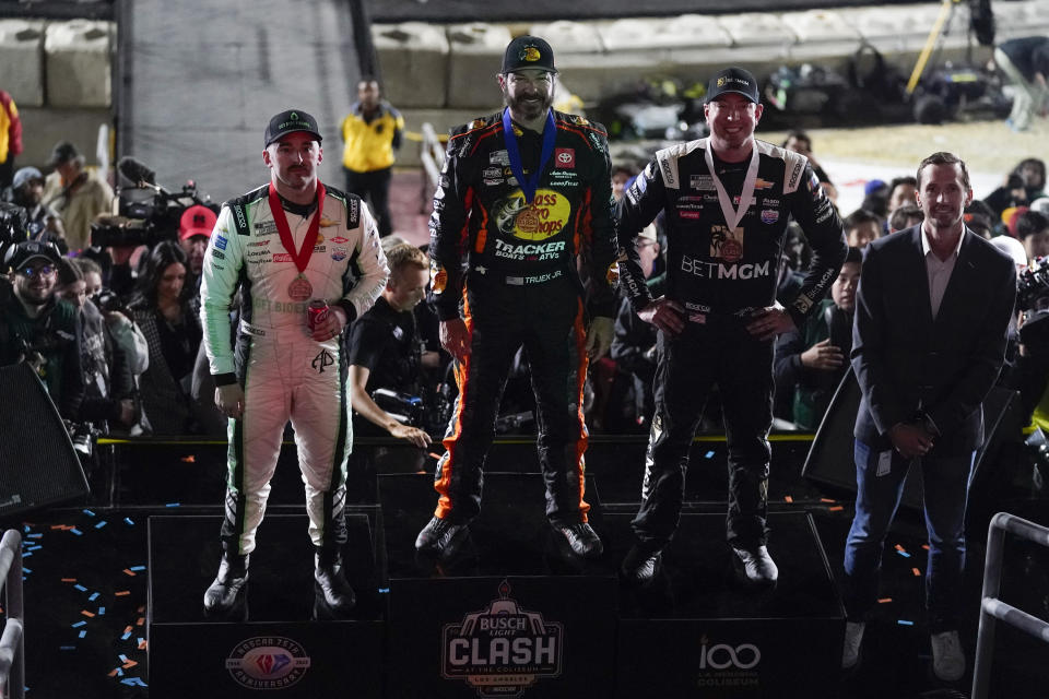 From left, second place winner Austin Dillon (3), Martin Truex Jr. (19), and Kyle Busch (8) pose for a photo after receiving their medals after a NASCAR exhibition auto race at Los Angeles Memorial Coliseum, Sunday, Feb. 5, 2023, in Los Angeles. (AP Photo/Ashley Landis)