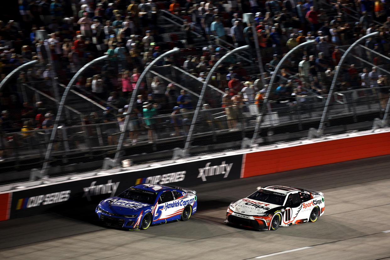 DARLINGTON, SOUTH CAROLINA - SEPTEMBER 01: Kyle Larson, driver of the #5 HendrickCars.com Chevrolet, and Denny Hamlin, driver of the #11 Sport Clips Haircuts Toyota, race during the NASCAR Cup Series Cook Out Southern 500 at Darlington Raceway on September 01, 2024 in Darlington, South Carolina. (Photo by Jared C. Tilton/Getty Images)