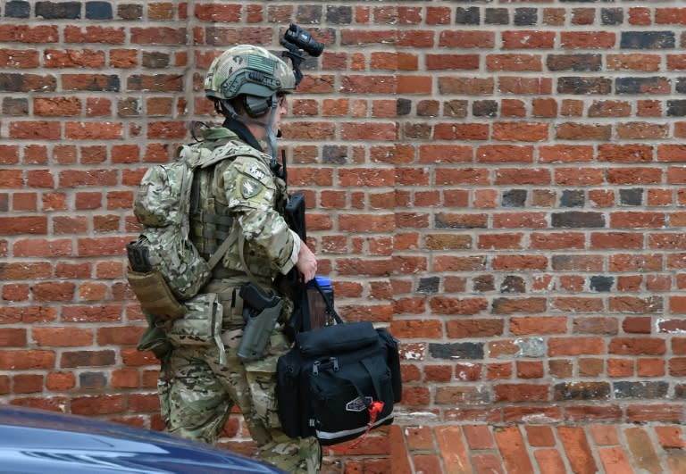 Military security arrives near the scene of an unconfirmed shooting at the Navy Yard in Washington, DC on July 2, 2015. The Navy Yard in Washington was put on lockdown Thursday amid unconfirmed reports of an active gunman on the military facility, the scene of a deadly shooting two years ago, the US Navy said. A Navy officer who was inside the complex told CNN people scrambled for cover after hearing someone shout to get out of the building and stay away from the cafeteria. But Lieutenant Commander Scott Williams said he heard no shots or saw any signs of a struggle. "We heard someone scream, get out of the building, stay away from the cafeteria and we saw everyone running for the exits or adjoining offices," he said. AFP PHOTO/ MLADEN ANTONOV