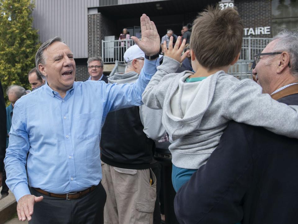 François Legault, head of the Coalition Avenir Québec, greets supporters after casting his ballot in L'Assomption, Que. ahead of the provincial election on Oct. 3. THE CANADIAN PRESS/Graham Hughes