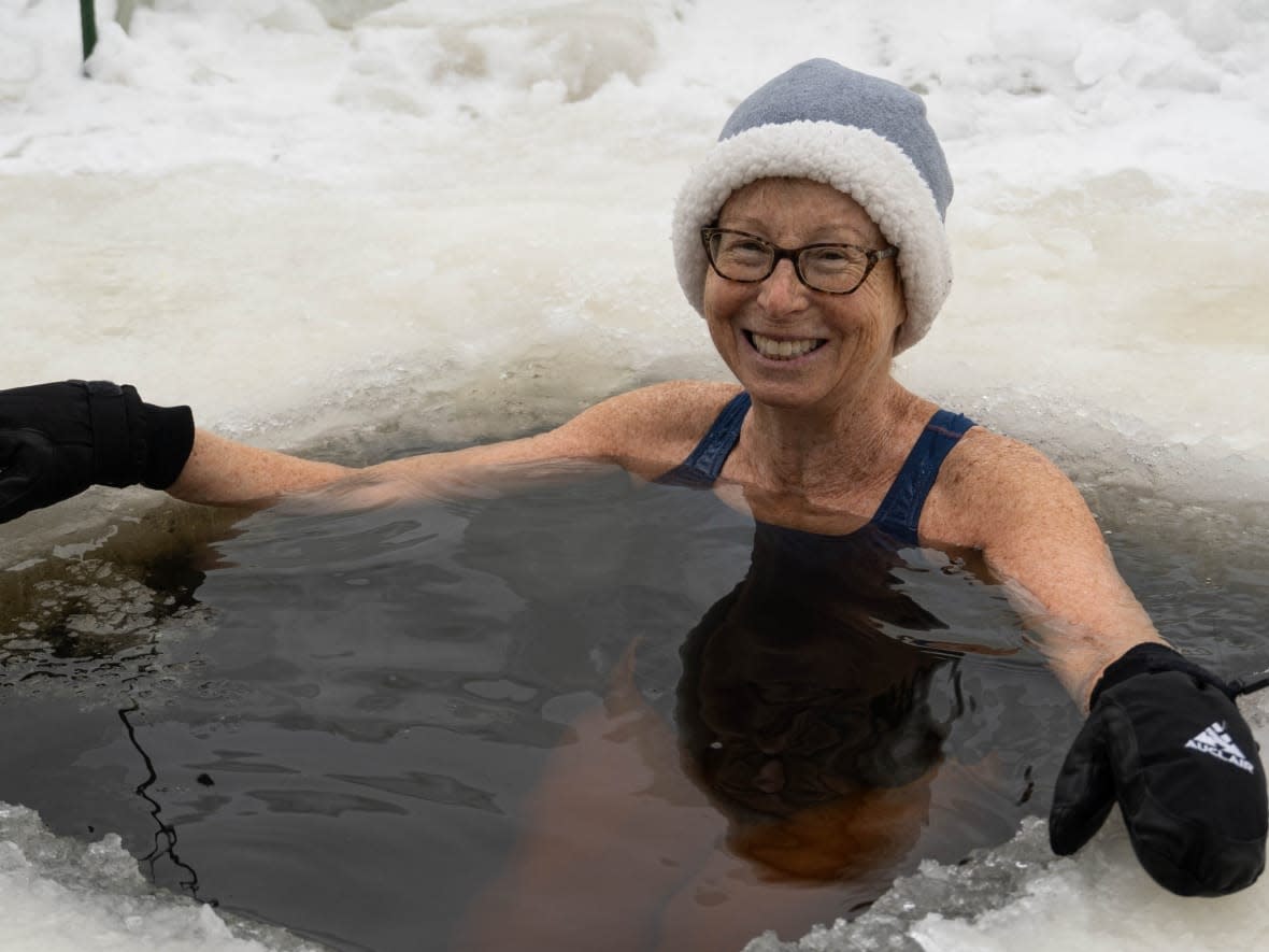 Judith Lockett is all smiles while she's immersed in the icy cold water. (Jean Delisle/CBC - image credit)