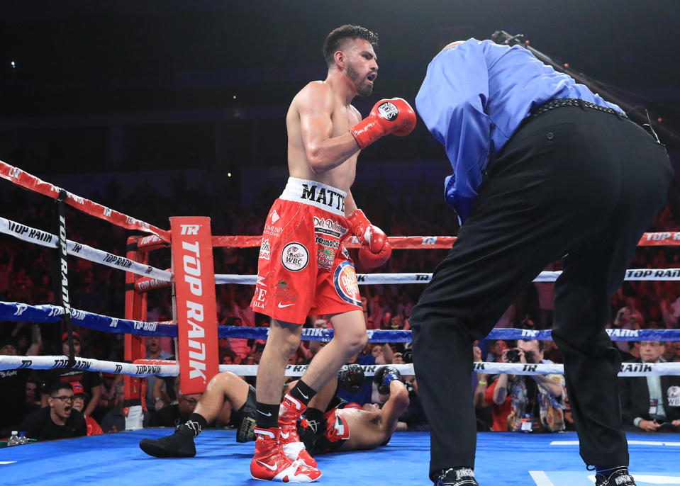 Jose Ramirez heads to a neutral corner after knocking Antonio Orozco down with a body shot in their WBC super lightweight world title fight Friday. (Top Rank)