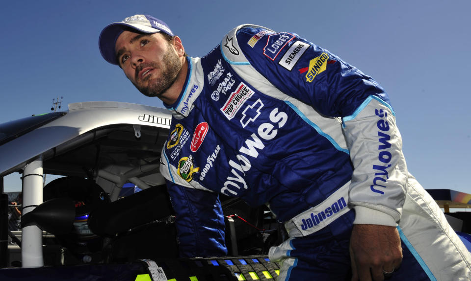 Sprint Cup Series driver Jimmie Johnson (48) climbs out of his car after qualifying for the Good Sam Club 500 auto race at the Talladega Superspeedway in Talladega, Ala., Saturday, Oct. 22, 2011. (AP Photo/Rainier Ehrhardt)