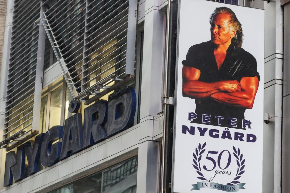 A sign featuring a picture of Peter Nygard outside his Times Square offices in New York City (AP)