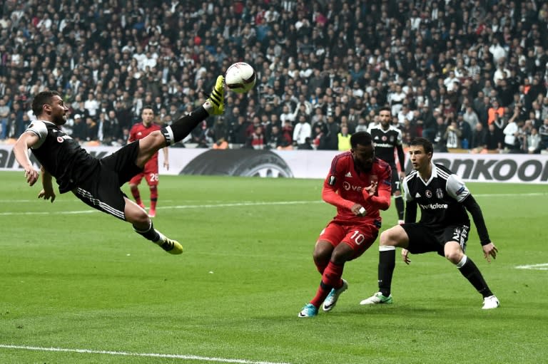 Besiktas' Dusko Tosic (LO) kicks the ball next to Lyon's Alexandre Lacasette (C) during the UEFA Europa League second leg quarter final football match April 20, 2017