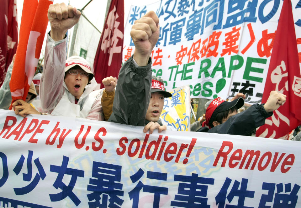 FILE - In this March 23, 2008 file photo, protesters shout a slogan during a rally against an alleged rape in February of a 14-year-old girl by an American serviceman in Okinawa islands, southwestern Japan. An Associated Press investigation into the military’s handling of sexual assaults in Japan has found a pattern of random and inconsistent judgments in which most offenders are not incarcerated. Instead, commanders have ordered “nonjudicial punishments” that ranged from docked pay to a letter of reprimand. (AP Photo/Itsuo Inouye, File)