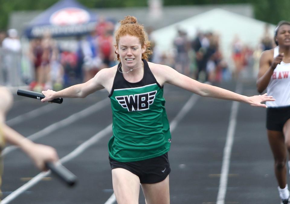 West Branch's Anna Lippiatt leans across the finish line after running the anchor leg of the girls 4x200 meter relay final at the Division II track and field regional finals held at Austintown Fitch High School, Saturday, May 28, 2022.